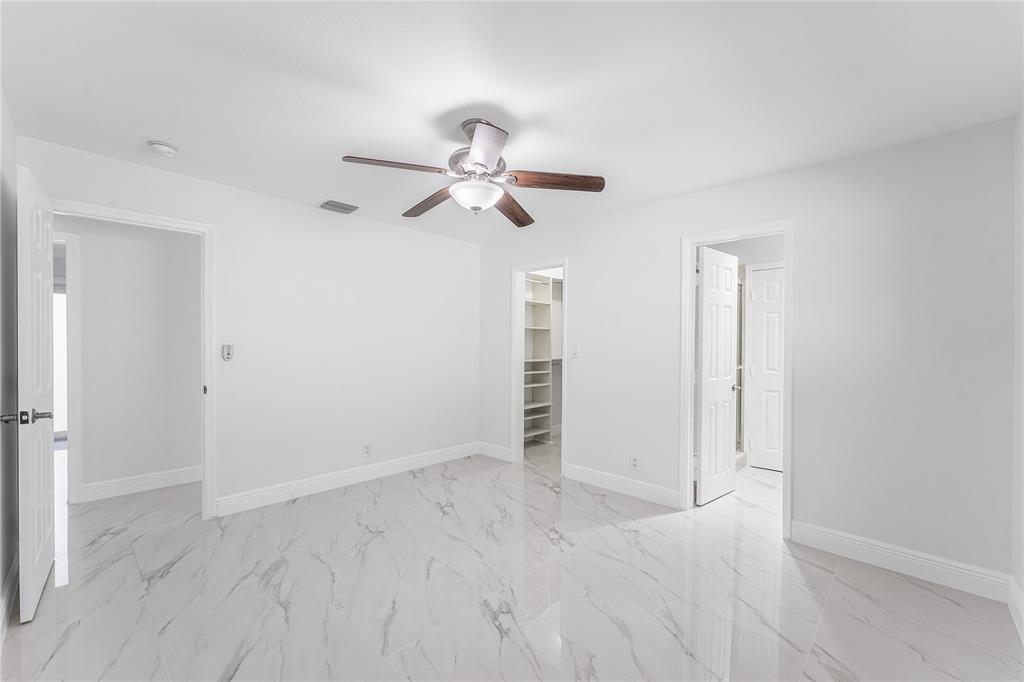2443 Northeast 26th Street Lighthouse Point, FL 33064 - Photo 38 of 67 an empty room with closet and a ceiling fan
