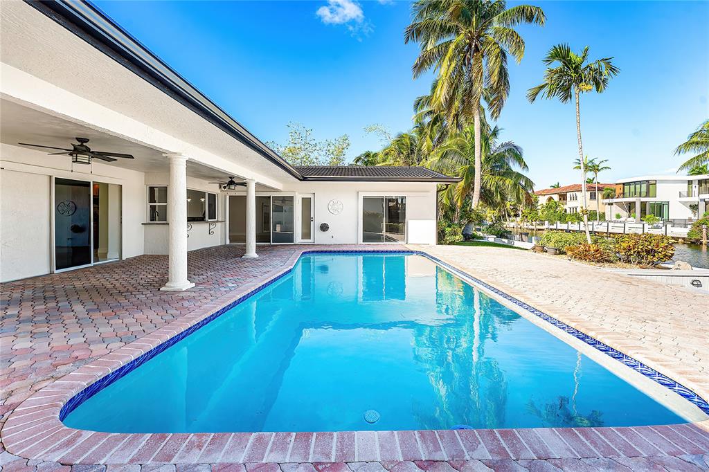 2443 Northeast 26th Street Lighthouse Point, FL 33064 - Photo 47 of 67 a view of a house with swimming pool