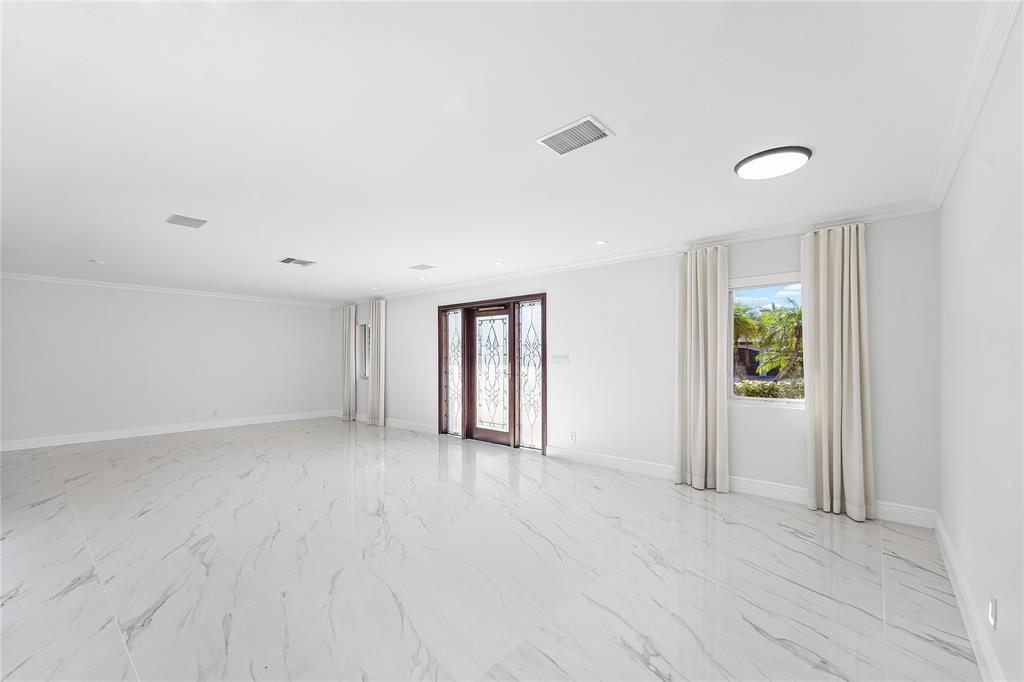 2443 Northeast 26th Street Lighthouse Point, FL 33064 - Photo 9 of 67 an empty room with windows and closet