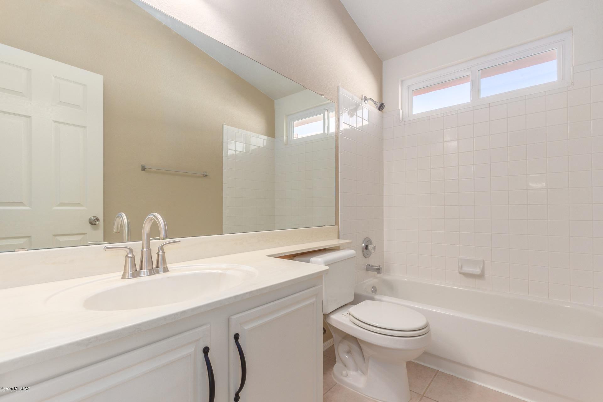 3580 West Sky Ridge Loop Tucson, AZ 85742 - Photo 22 of 29 a bathroom with a sink a toilet and a bathtub