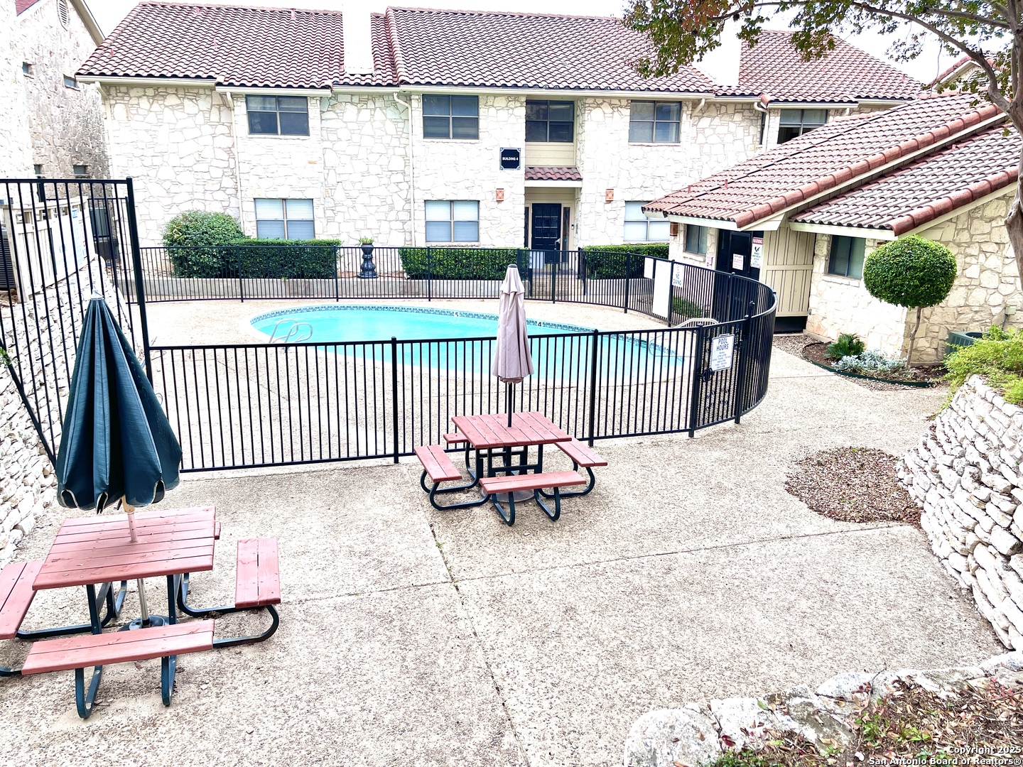 7738 Chambers Road, Unit 403 San Antonio, TX 78229 - Photo 1 of 37 a view of a patio with a table and chairs