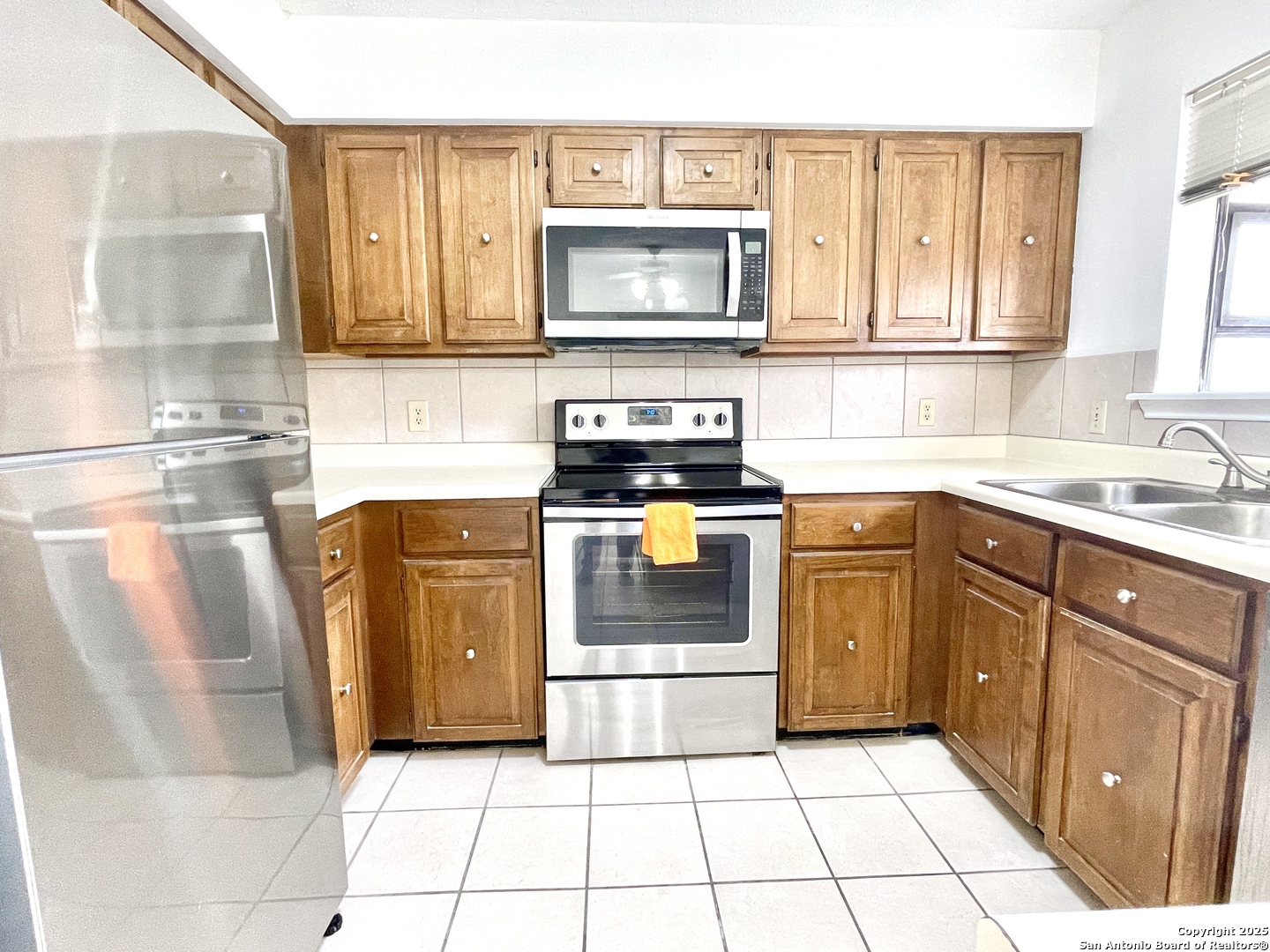 7738 Chambers Road, Unit 403 San Antonio, TX 78229 - Photo 17 of 37 a kitchen with stainless steel appliances granite countertop a stove a sink and a microwave