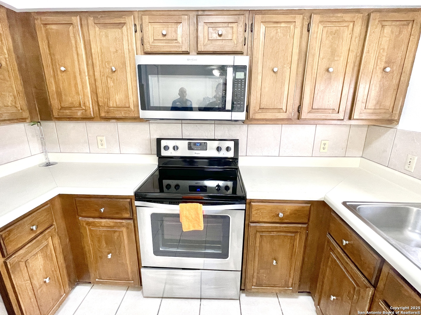 7738 Chambers Road, Unit 403 San Antonio, TX 78229 - Photo 18 of 37 a kitchen with granite countertop cabinets stainless steel appliances and a sink