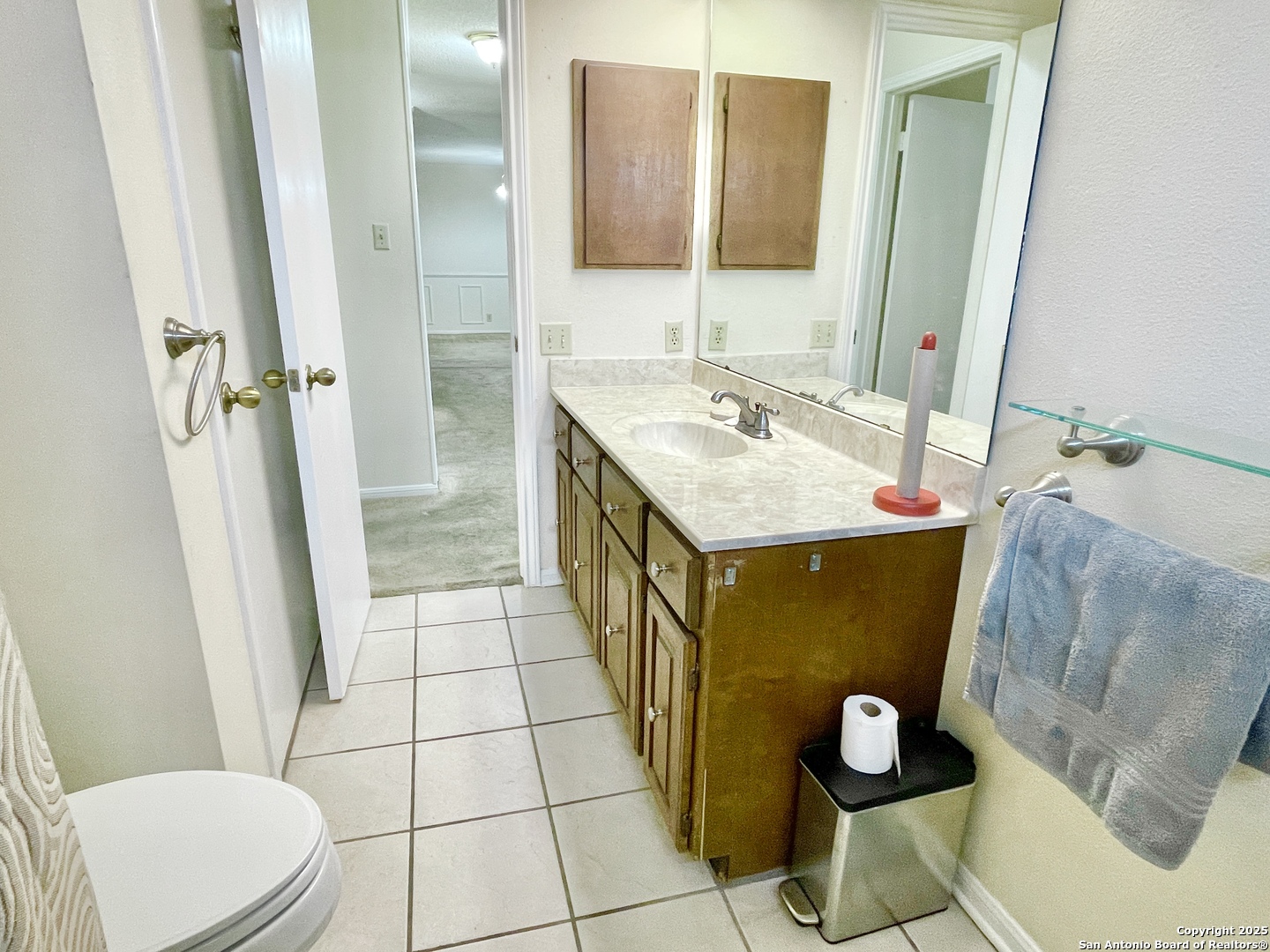 7738 Chambers Road, Unit 403 San Antonio, TX 78229 - Photo 22 of 37 a bathroom with a sink mirror vanity and toilet