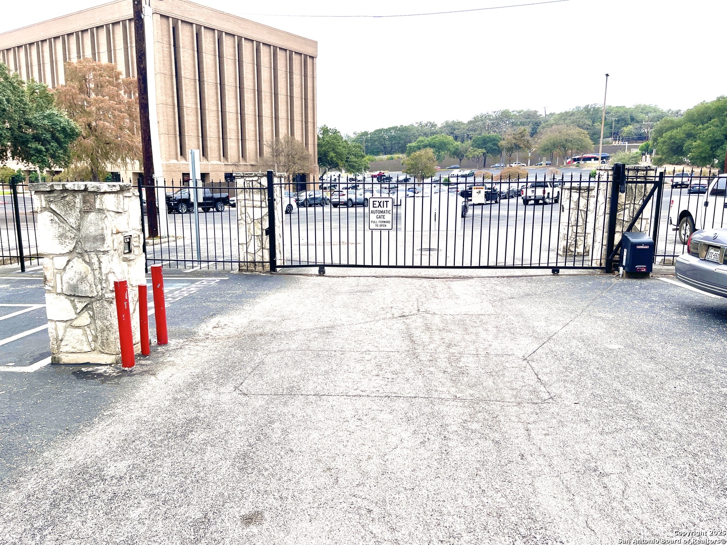 7738 Chambers Road, Unit 403 San Antonio, TX 78229 - Photo 7 of 37 a view of a gate with a small yard and wooden fence