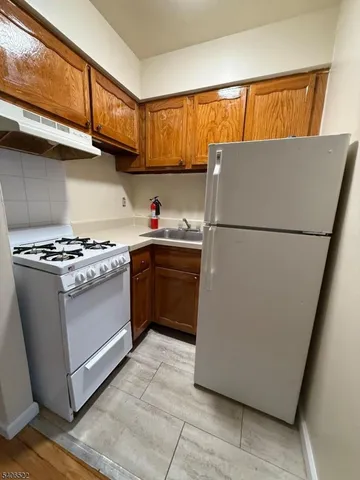 a white refrigerator freezer sitting in a kitchen