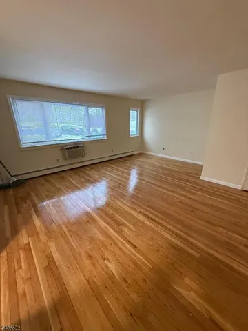 a view of a room with wooden floor