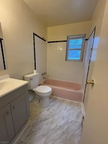 a bathroom with a toilet a sink and bathtub