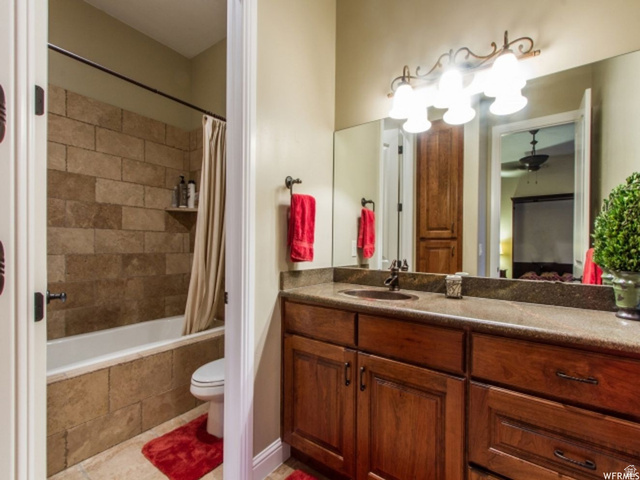 4378 Foothill Drive Bountiful, UT 84010 - Photo 34 of 46 Bathroom vanity with a dark wood-finish cabinet, integrated sink, and stone-finish countertop