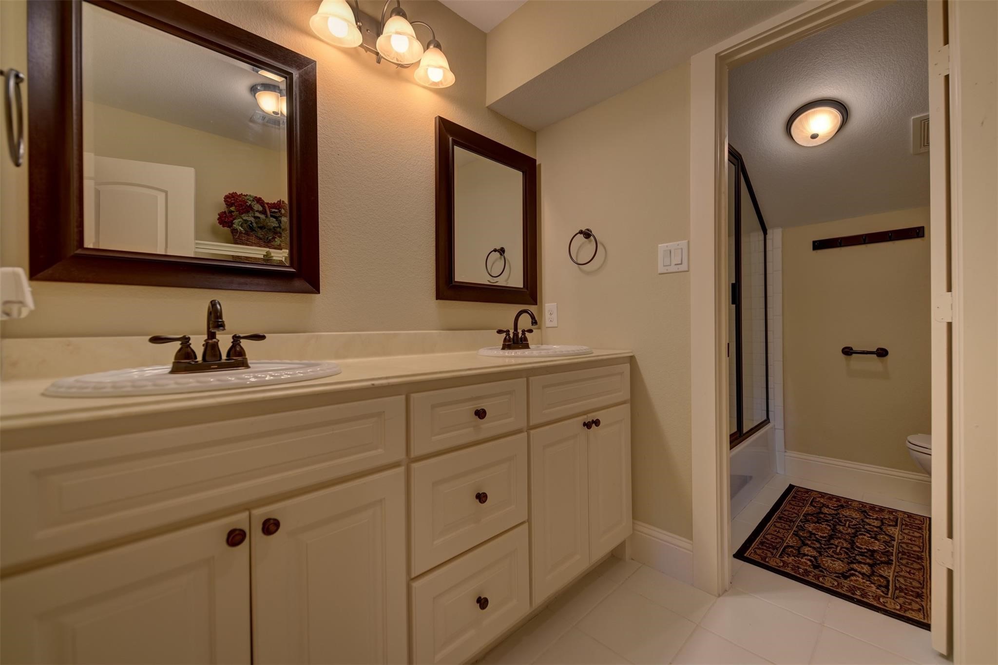 8456 Schuster Road Ledbetter, TX 78946 - Photo 31 of 49 a bathroom with a sink a mirror a vanity and a shower