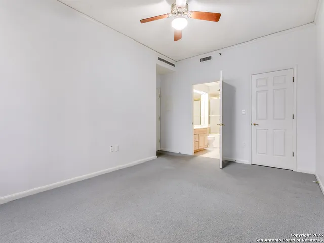 a spacious bathroom with a shower sink mirror and toilet