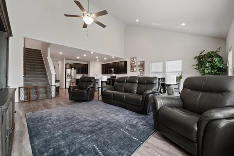 a living room with furniture and a chandelier