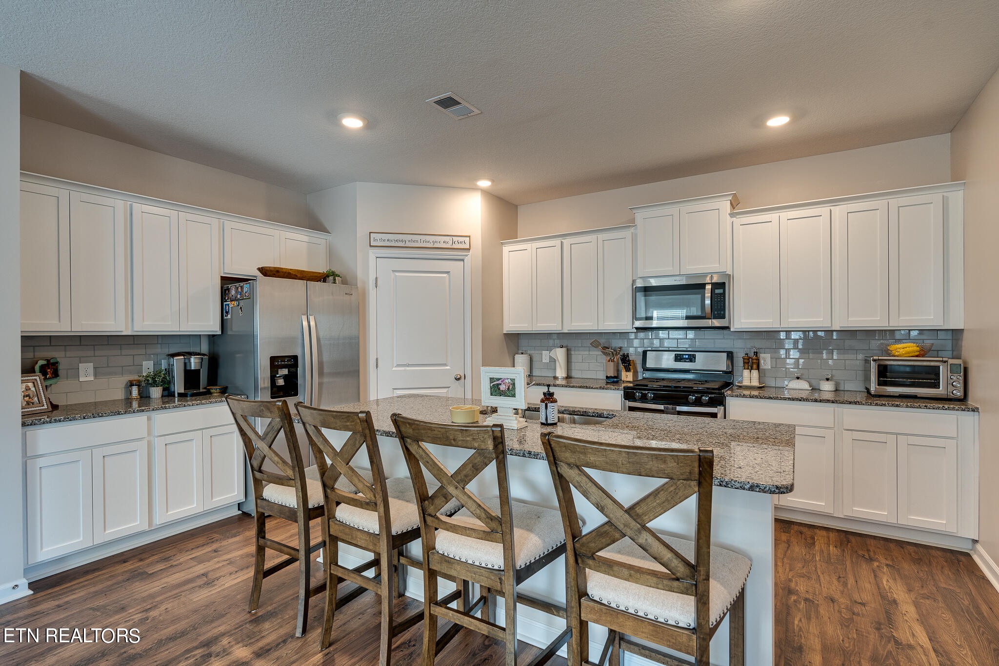 1117 Beacon Road Sevierville, TN 37876 - Photo 15 of 55 a kitchen with stainless steel appliances a stove a sink a refrigerator and white cabinets