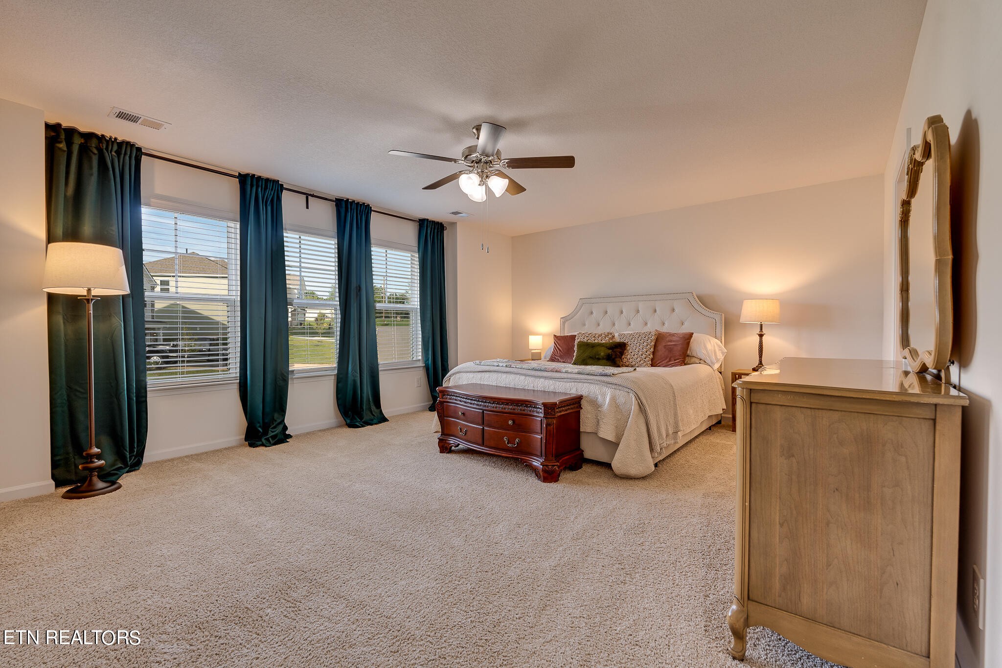 1117 Beacon Road Sevierville, TN 37876 - Photo 29 of 55 a bedroom with a large bed and a chandelier