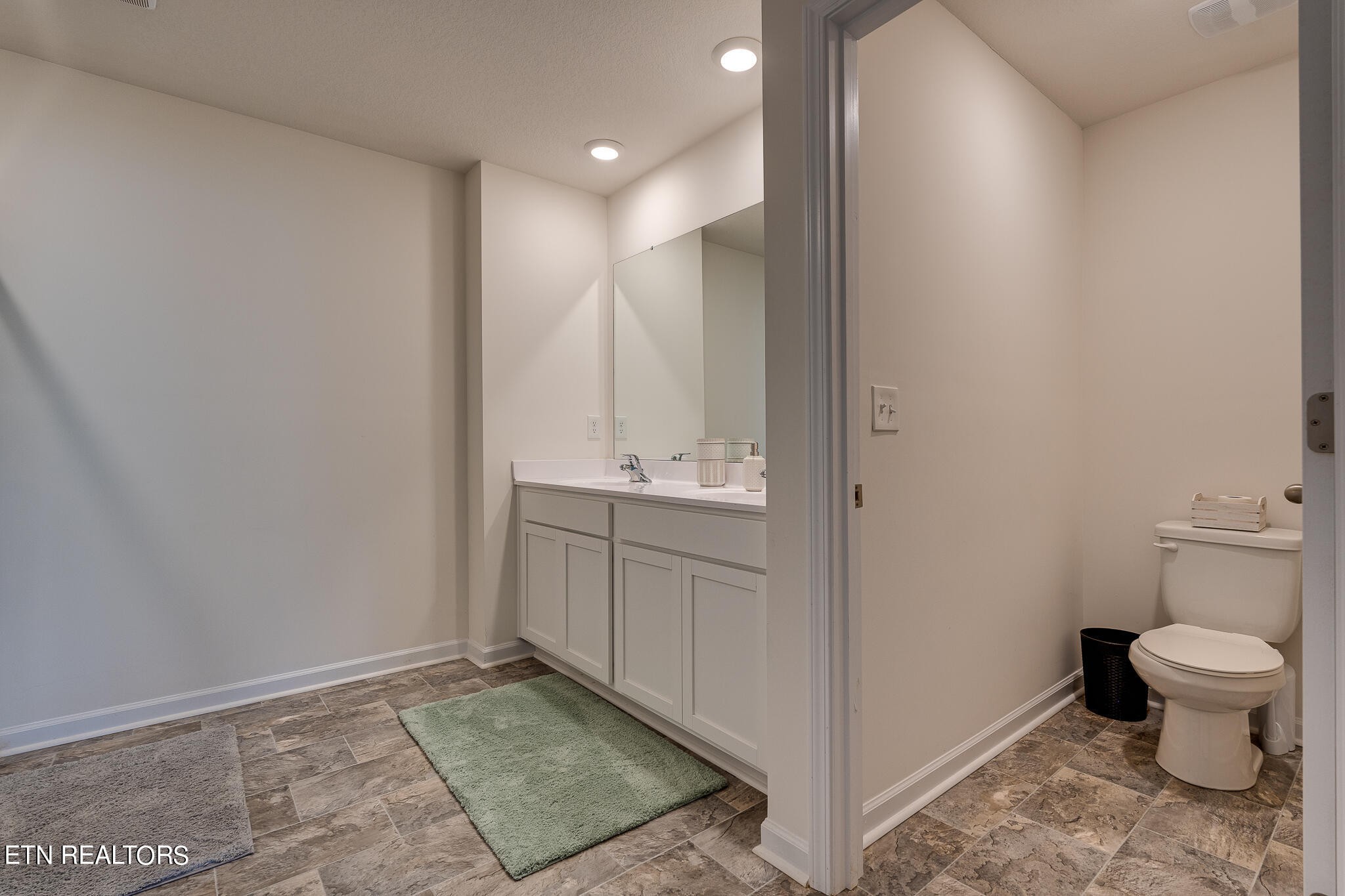 1117 Beacon Road Sevierville, TN 37876 - Photo 32 of 55 a bathroom with a sink a toilet and a mirror