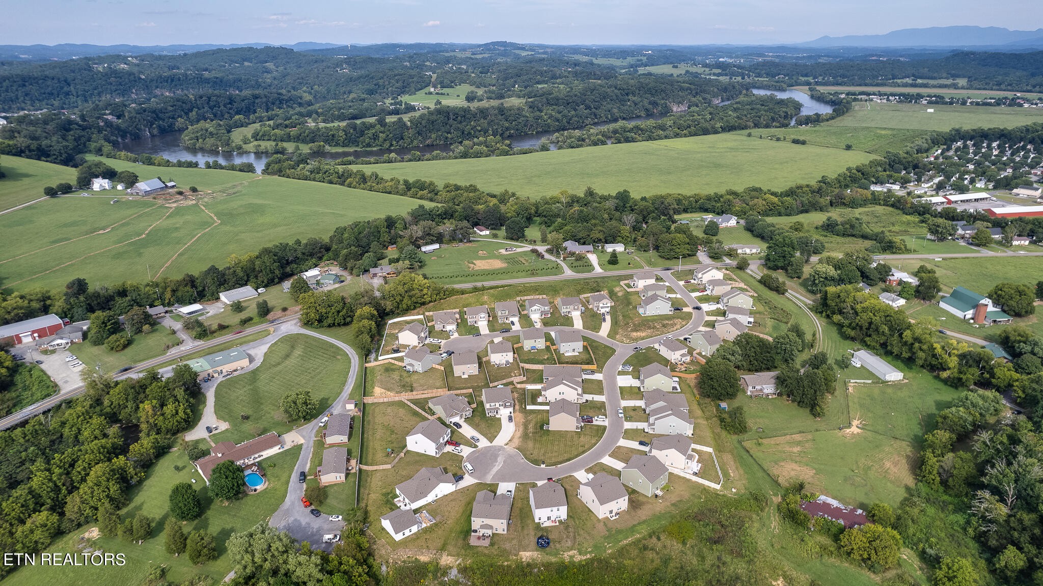 1117 Beacon Road Sevierville, TN 37876 - Photo 47 of 55 an aerial view of a houses with a lush green hillside