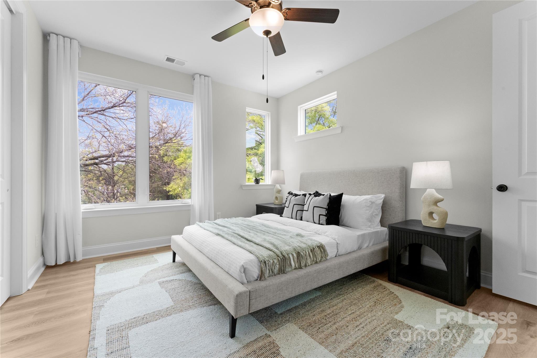 3232 Riley Avenue Charlotte, NC 28269 - Photo 11 of 19 a bedroom with a large bed chandelier and a window