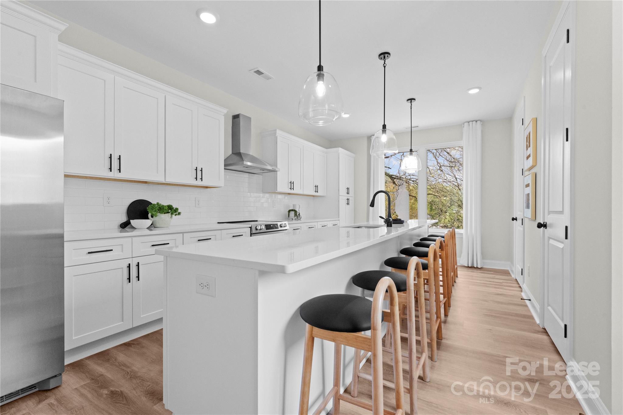3232 Riley Avenue Charlotte, NC 28269 - Photo 2 of 19 a kitchen with stainless steel appliances kitchen island a refrigerator sink and cabinets