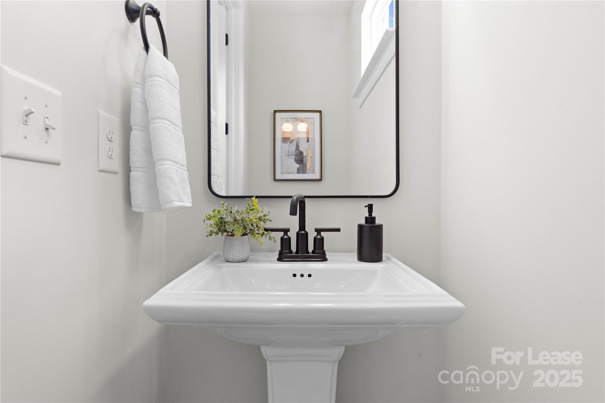 3232 Riley Avenue Charlotte, NC 28269 - Photo 10 of 19 a bathroom with a sink and a mirror