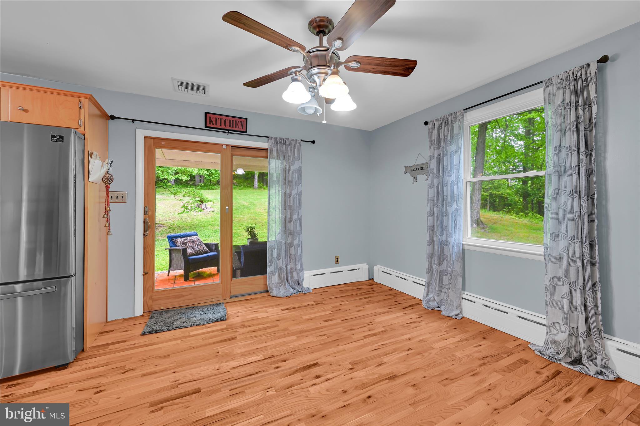 5220 Oley Turnpike Road Reading, PA 19606 - Photo 29 of 85 a big room with wooden floor a chandelier fan and windows