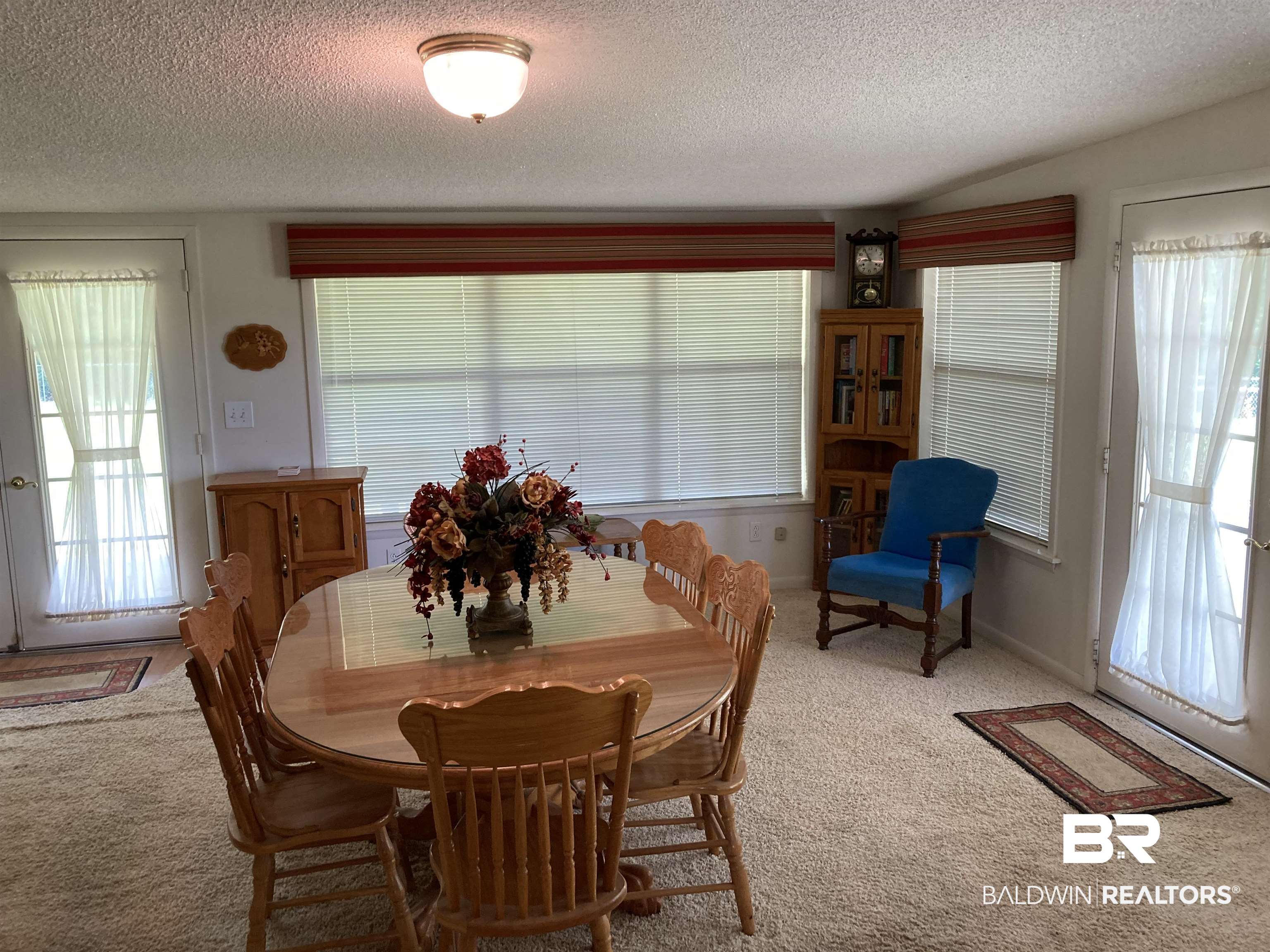 6151 Meadows Road Walnut Hill, FL 32568 - Photo 4 of 29 Dining area with light carpet and a textured ceiling