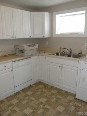 219 Gilbert Avenue Raleigh, NC 27603 - Photo 4 of 12 Newer white cabinetry, neutral countertops and flooring plus brushed nickle hardware make this space warm and inviting. Other