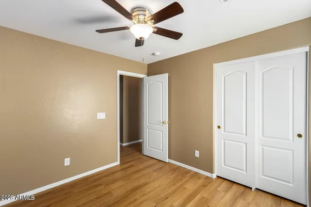 an empty room with wooden floor and door