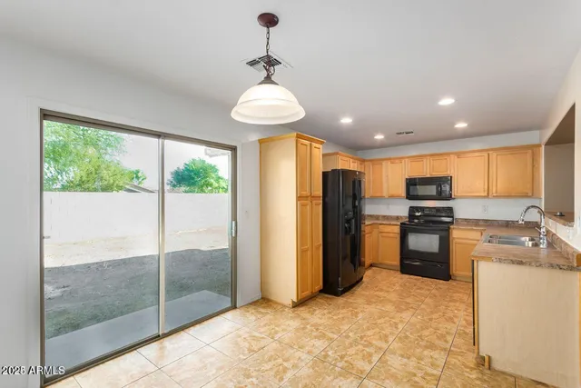 a kitchen with stainless steel appliances granite countertop a refrigerator and a stove top oven