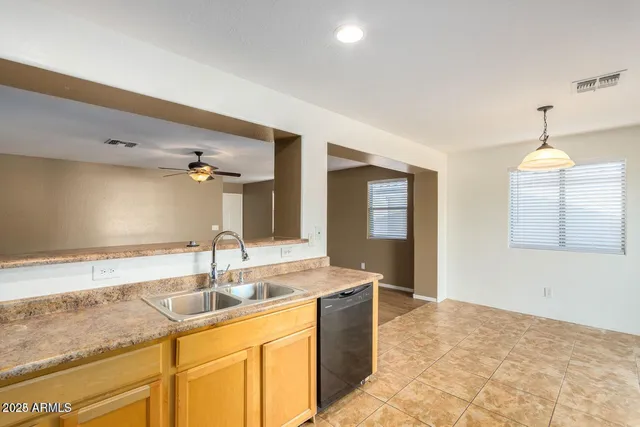 a kitchen with granite countertop a sink and a stove