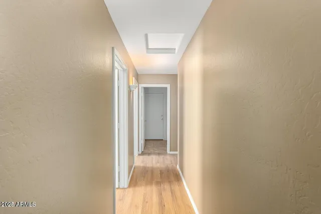 a view of a hallway with wooden floor