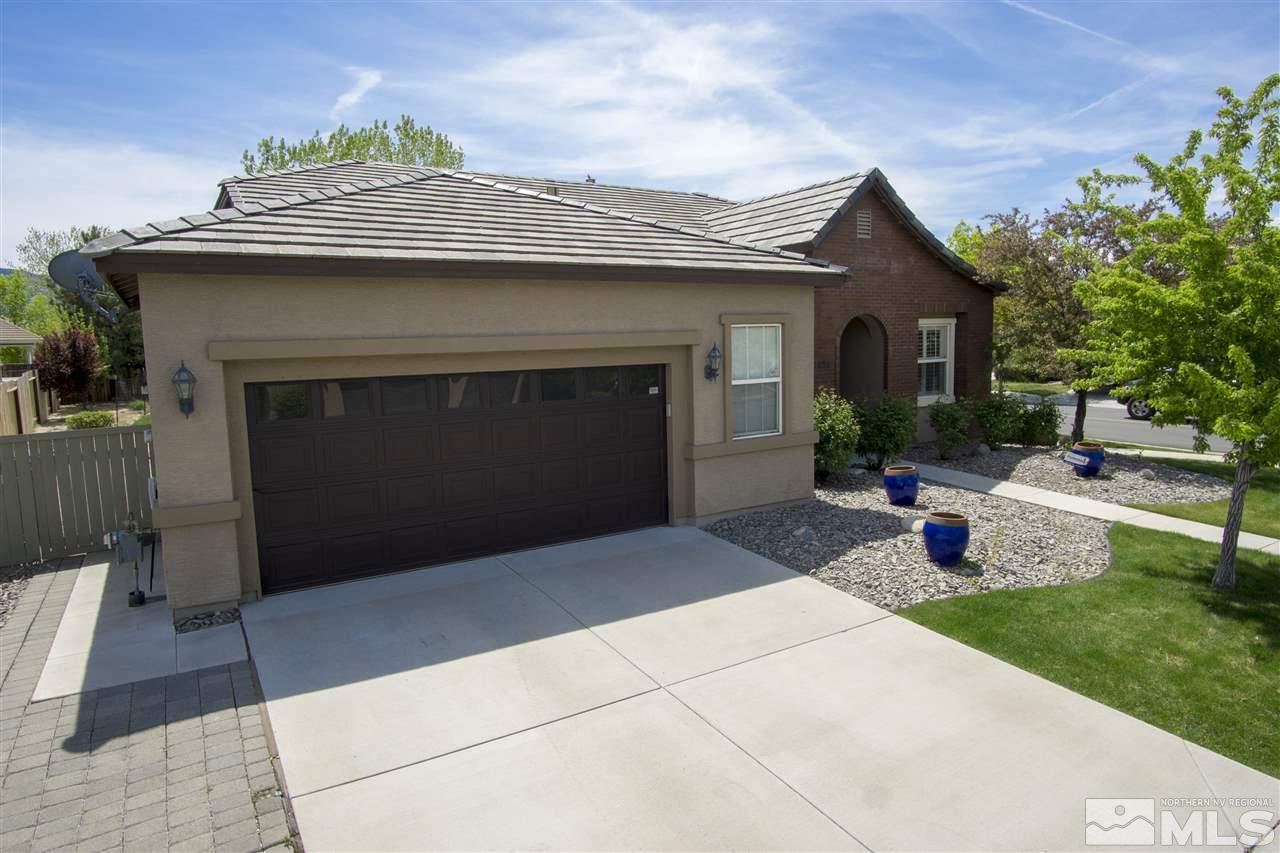 10598 Eagle Falls Way Reno, NV 89521 - Photo 2 of 17 a front view of a house with a garden