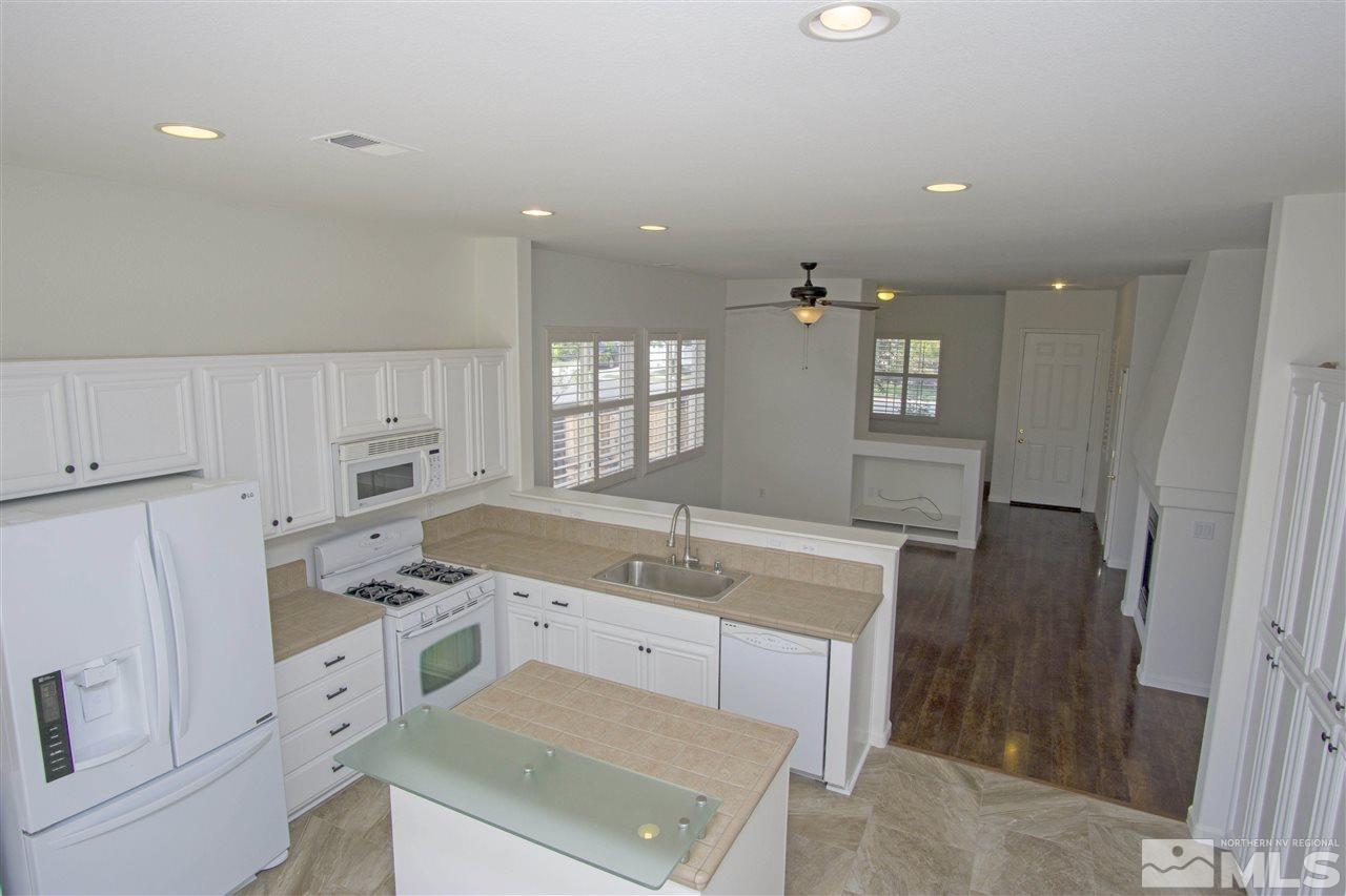 10598 Eagle Falls Way Reno, NV 89521 - Photo 4 of 17 a view of a kitchen with a sink cabinets and wooden floor