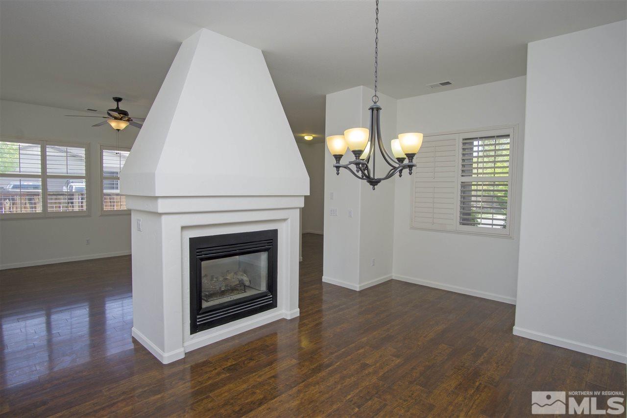 10598 Eagle Falls Way Reno, NV 89521 - Photo 6 of 17 a view of a livingroom with a fireplace a chandelier and wooden floor