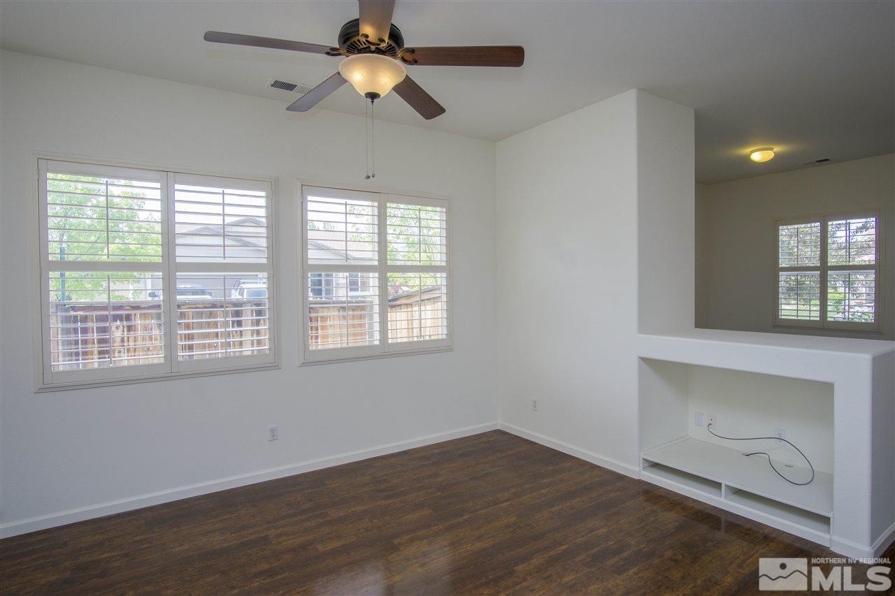 10598 Eagle Falls Way Reno, NV 89521 - Photo 7 of 17 a view of an empty room with a window and wooden floor