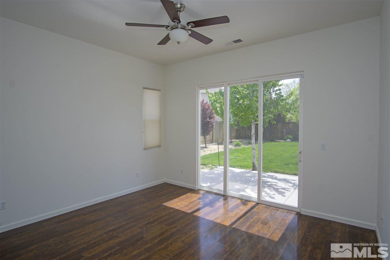 10598 Eagle Falls Way Reno, NV 89521 - Photo 8 of 17 a view of an empty room with wooden floor and a window