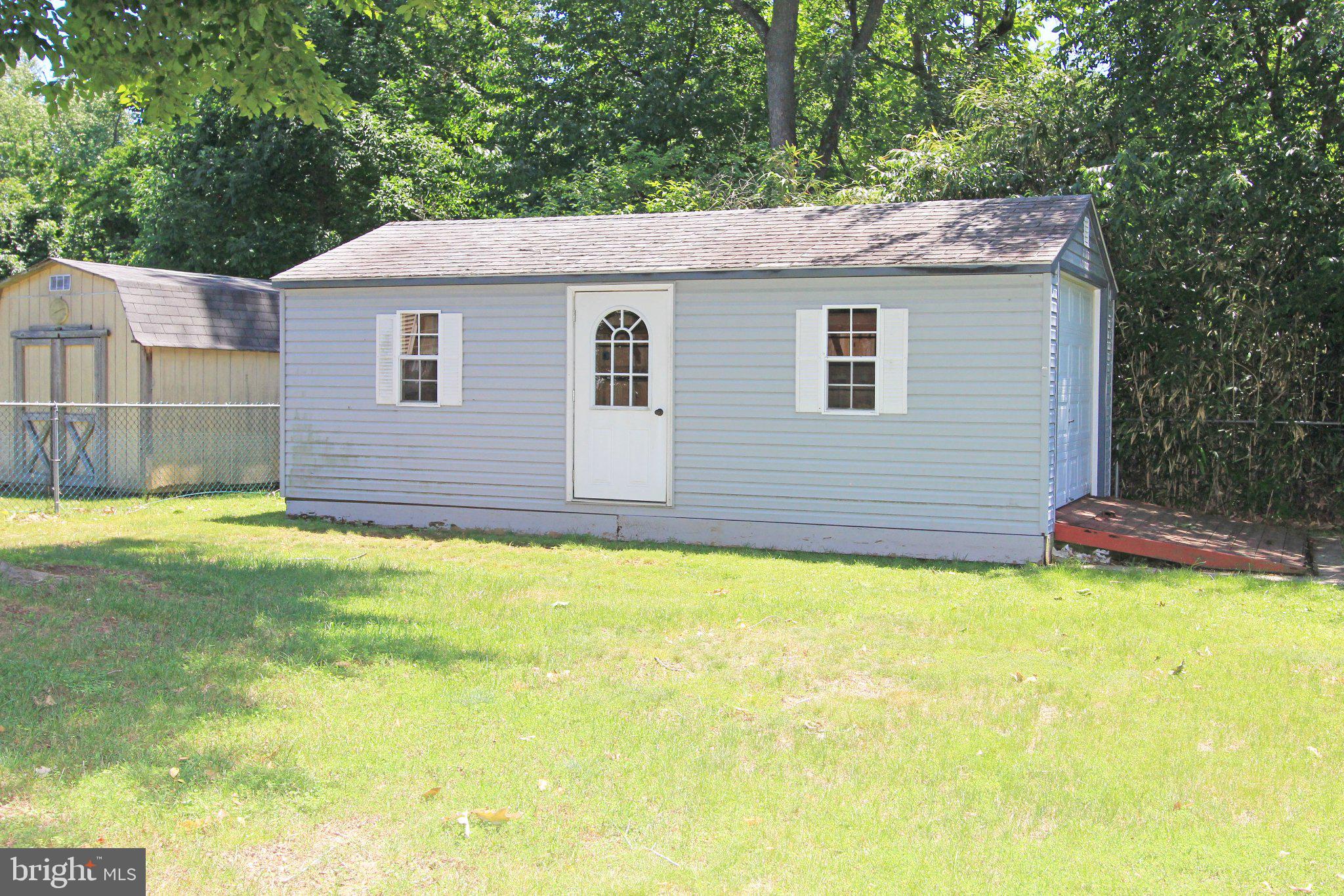 929 Cherry Tree Road Aston, PA 19014 - Photo 22 of 26 Charming blue shed in a lush setting.