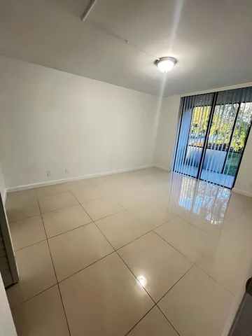 a view of an empty room and glass door