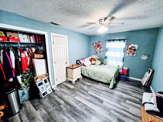 a bed room with a bed and a chair