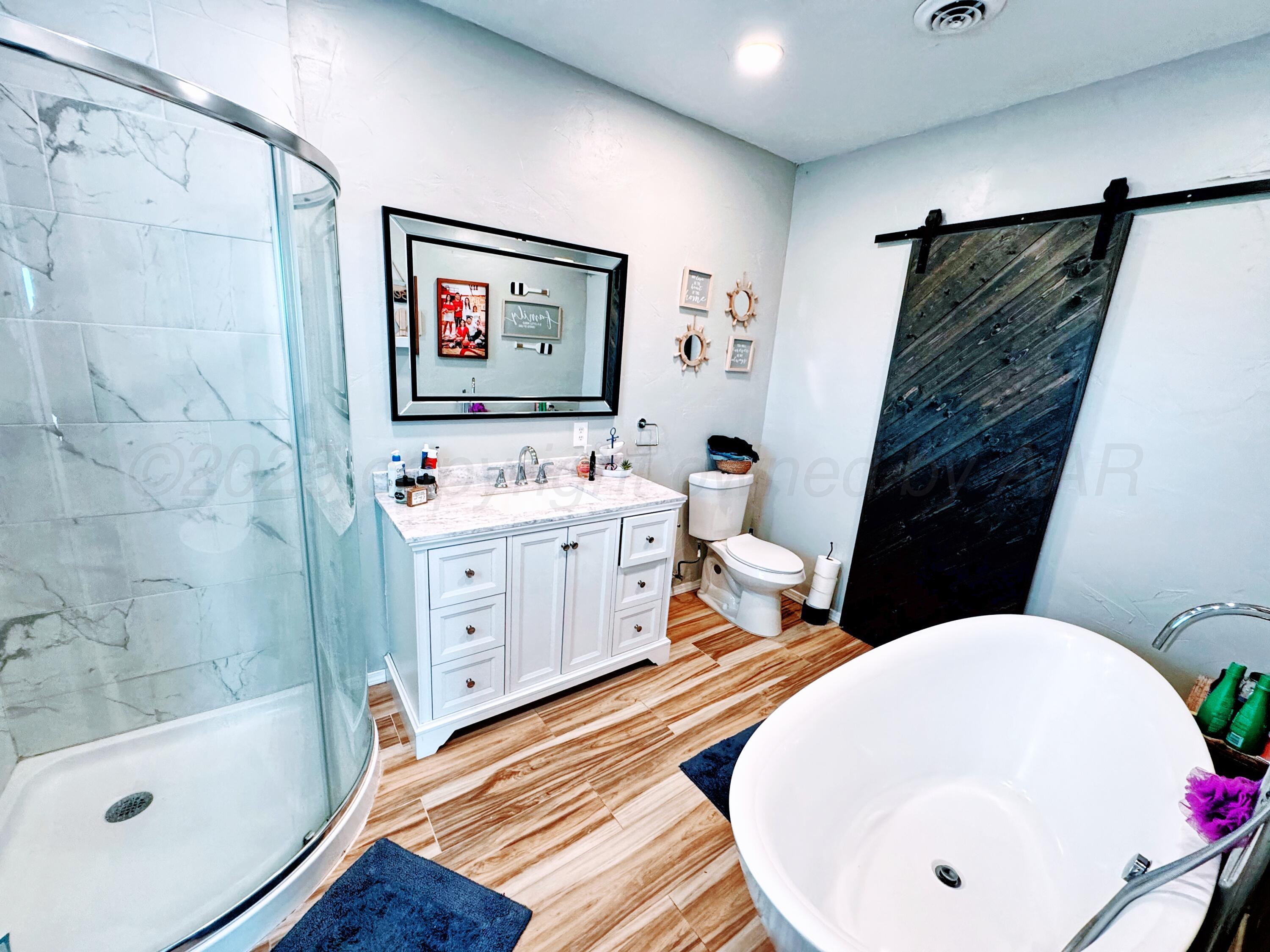 14155 County Road 7 Perryton, TX 79070 - Photo 15 of 25 a bathroom with a sink and a mirror