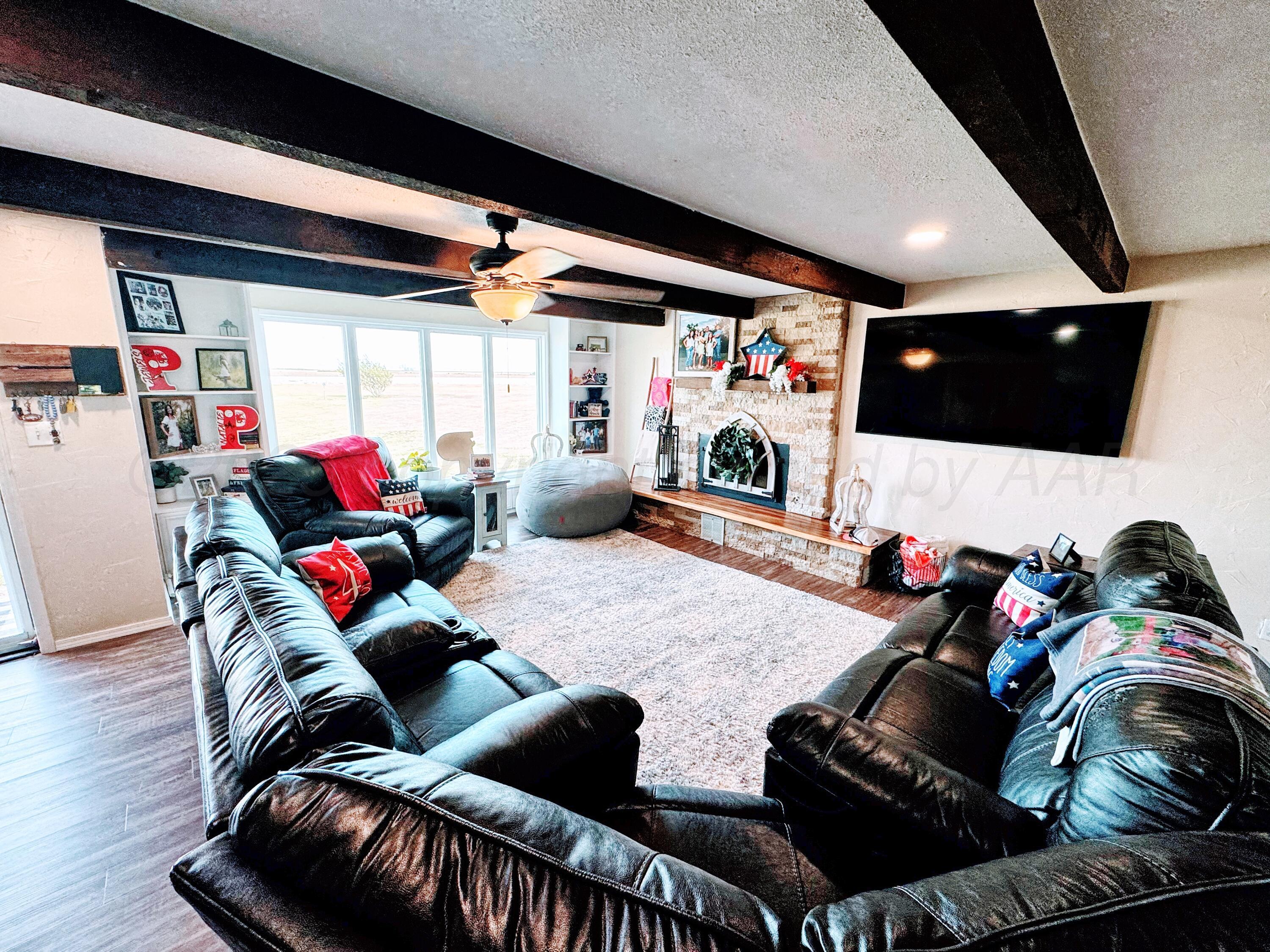 14155 County Road 7 Perryton, TX 79070 - Photo 4 of 25 a living room with furniture and a flat screen tv