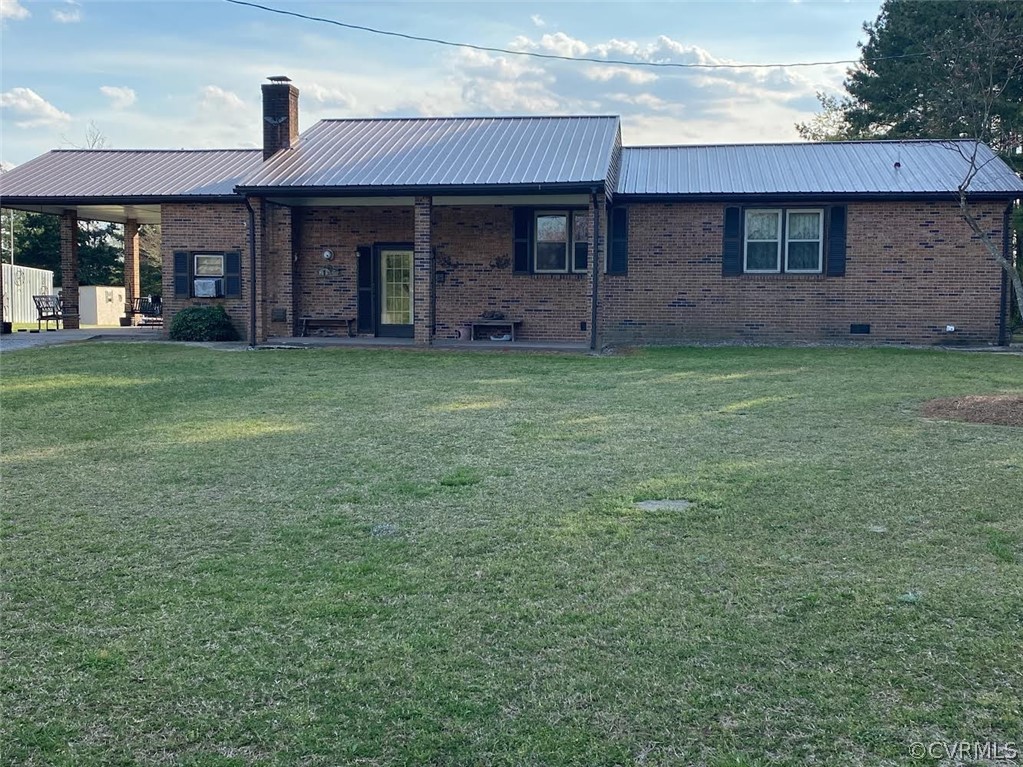 front view of a brick house with a yard