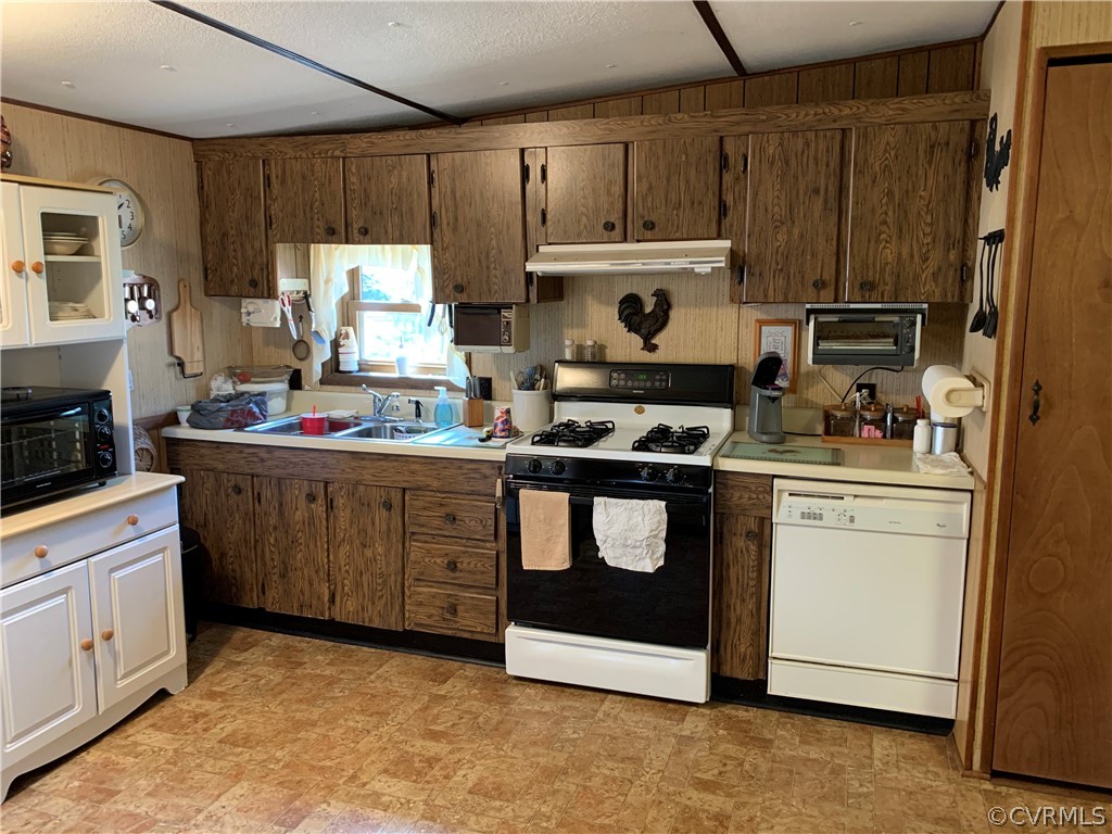 1079 CCC Road Crewe, VA 23930 - Photo 27 of 33 a kitchen with kitchen island granite countertop cabinets and white appliances