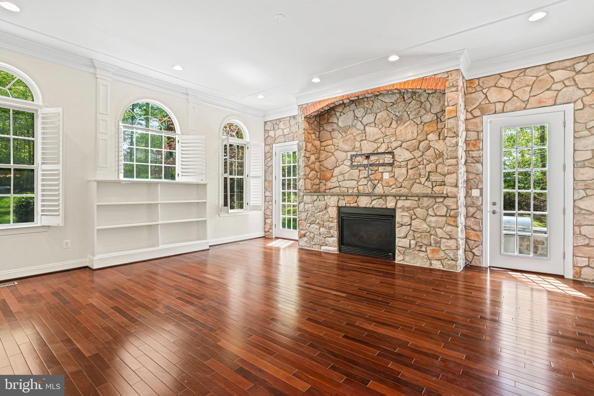 13551 Triadelphia Mill Road Clarksville, MD 21029 - Photo 11 of 74 an empty room with wooden floor fireplace and windows