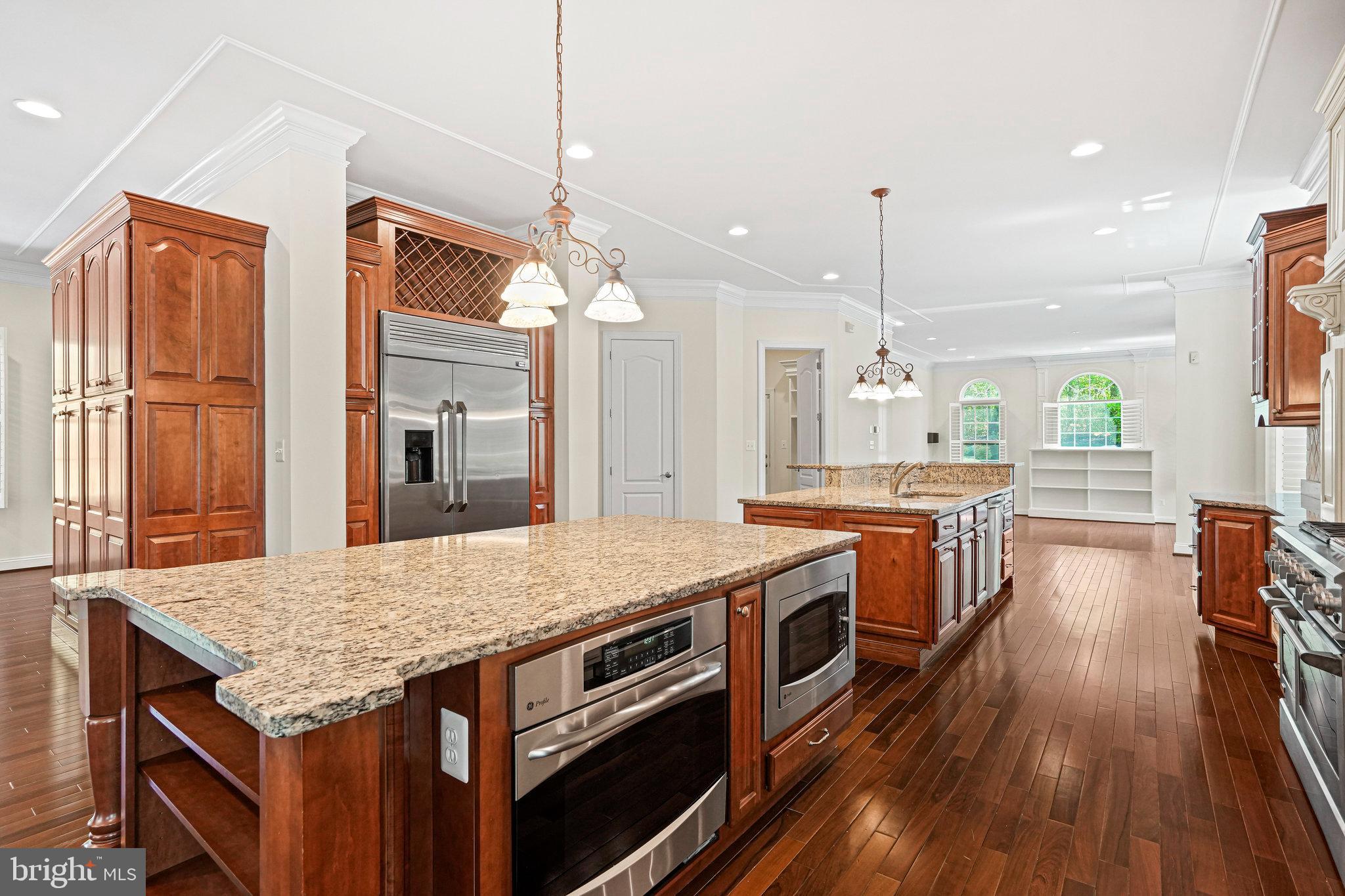 13551 Triadelphia Mill Road Clarksville, MD 21029 - Photo 16 of 74 a kitchen with stainless steel appliances granite countertop wooden floors and sink