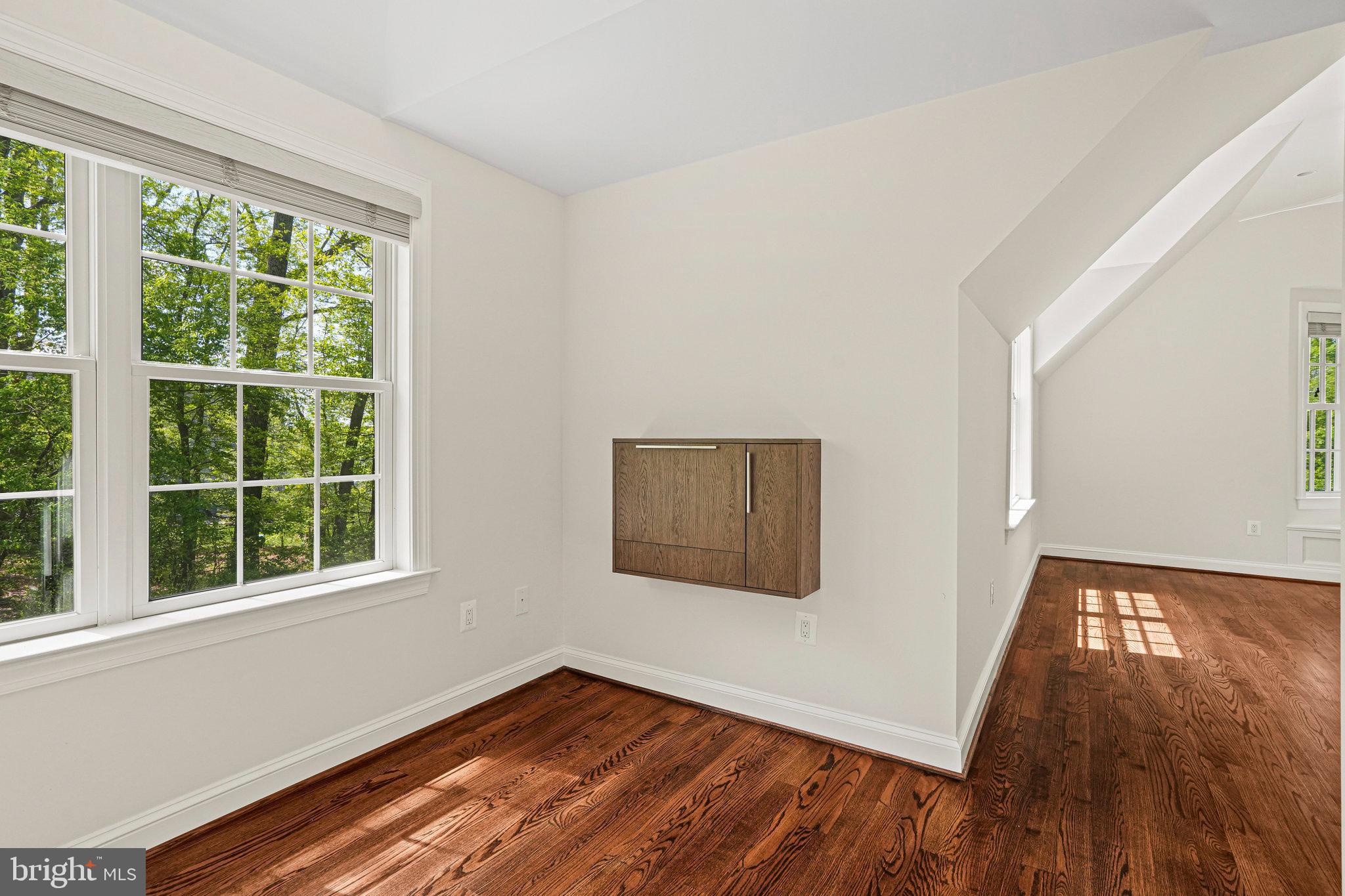 13551 Triadelphia Mill Road Clarksville, MD 21029 - Photo 41 of 74 a view of an empty room with wooden floor and a window