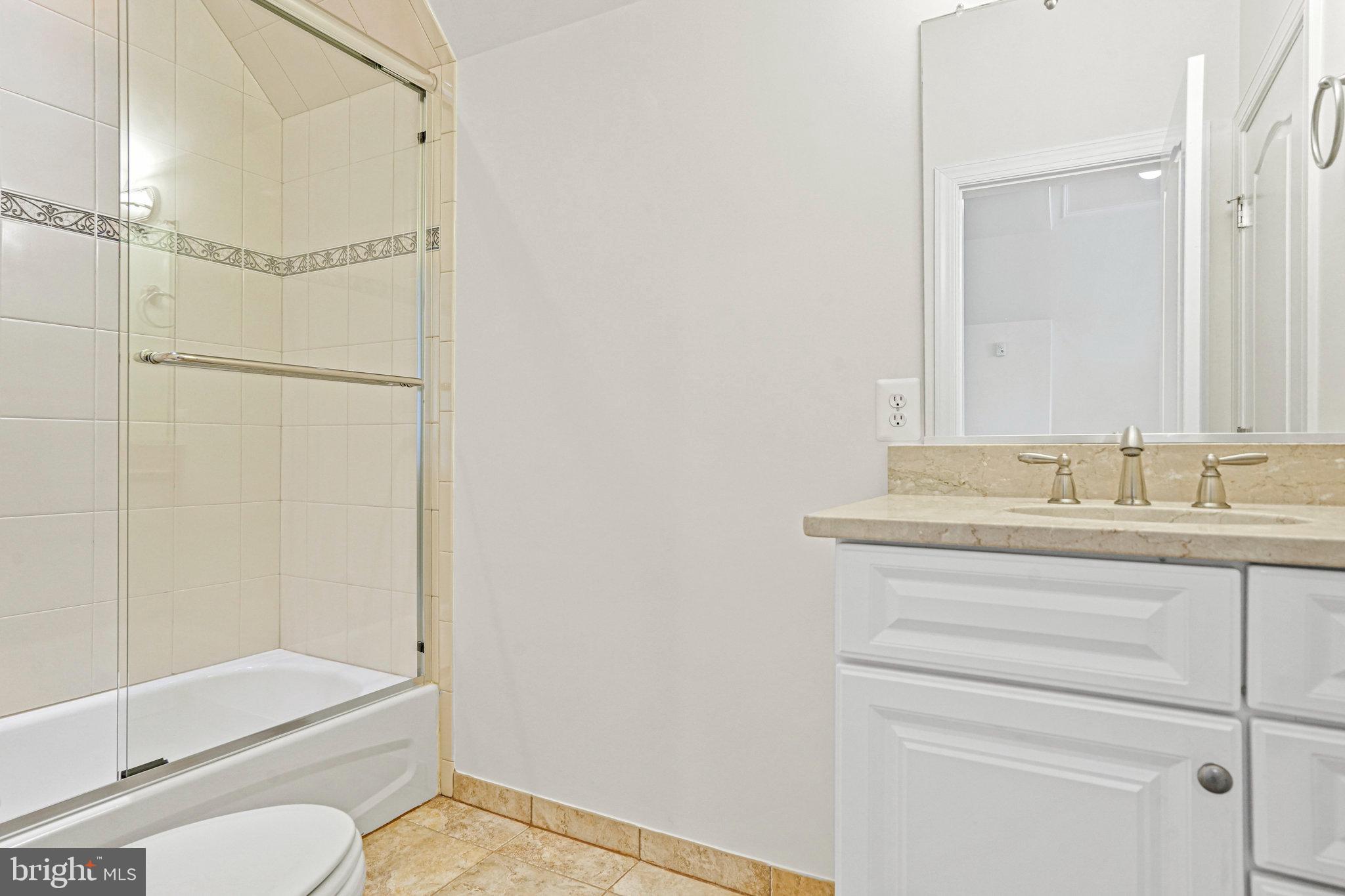 13551 Triadelphia Mill Road Clarksville, MD 21029 - Photo 53 of 74 a bathroom with a granite countertop sink toilet and shower