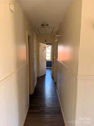 a kitchen with stainless steel appliances granite countertop a refrigerator a stove and a sink with wooden floor