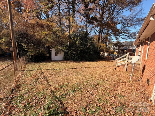 a front view of a house with a yard covered in snow