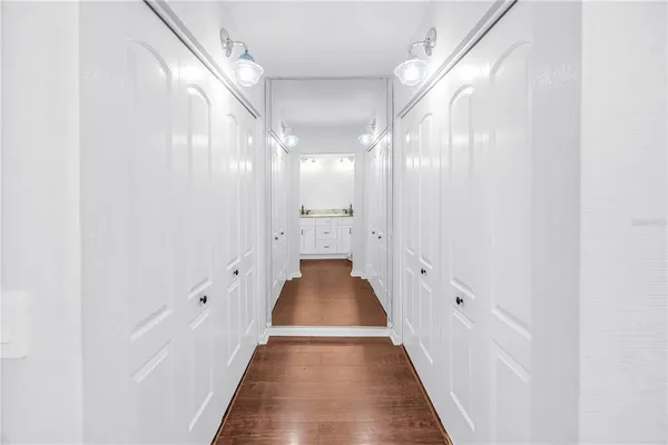 a view of a hallway with wooden floor