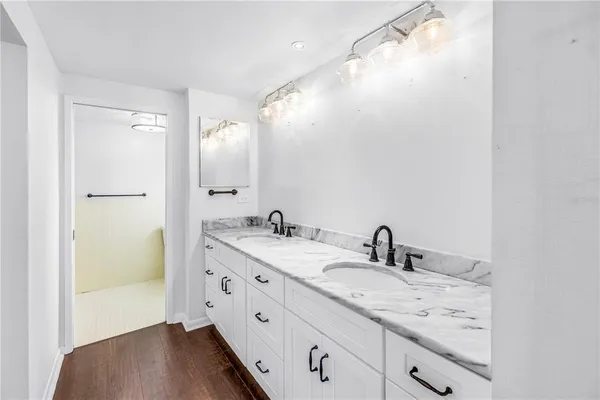 a bathroom with a double vanity sink and mirror